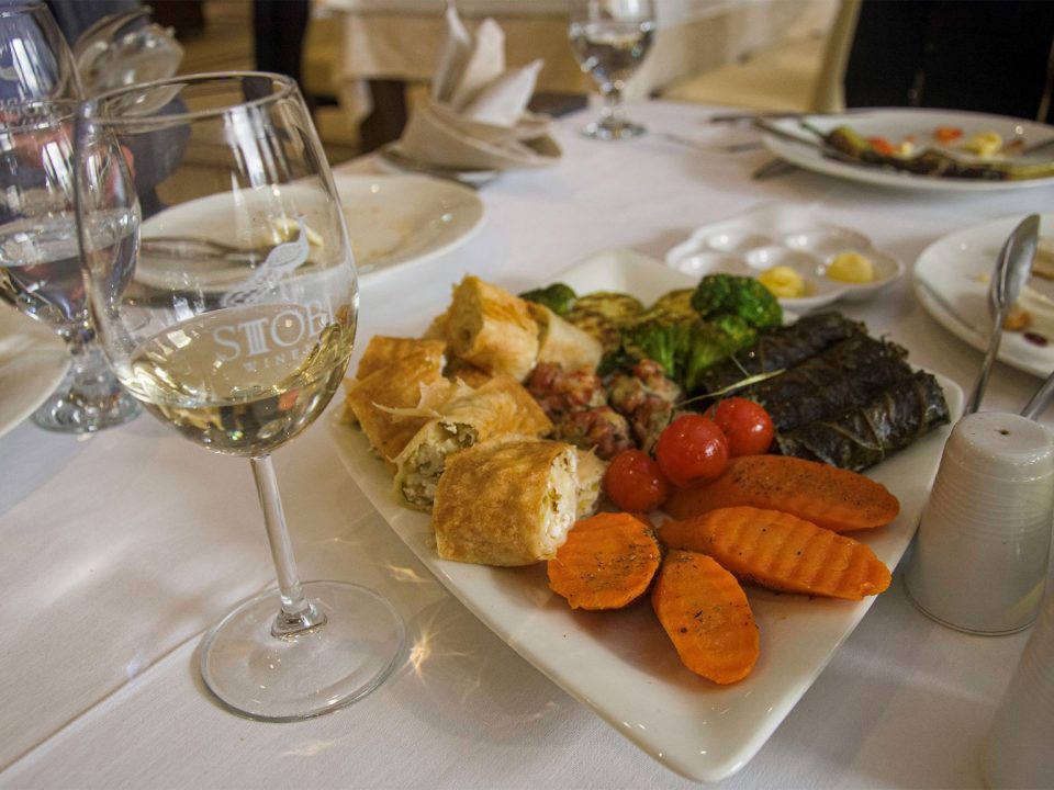 White wine in glass together with food on a restaurant in Stoby winery, Macedonia.